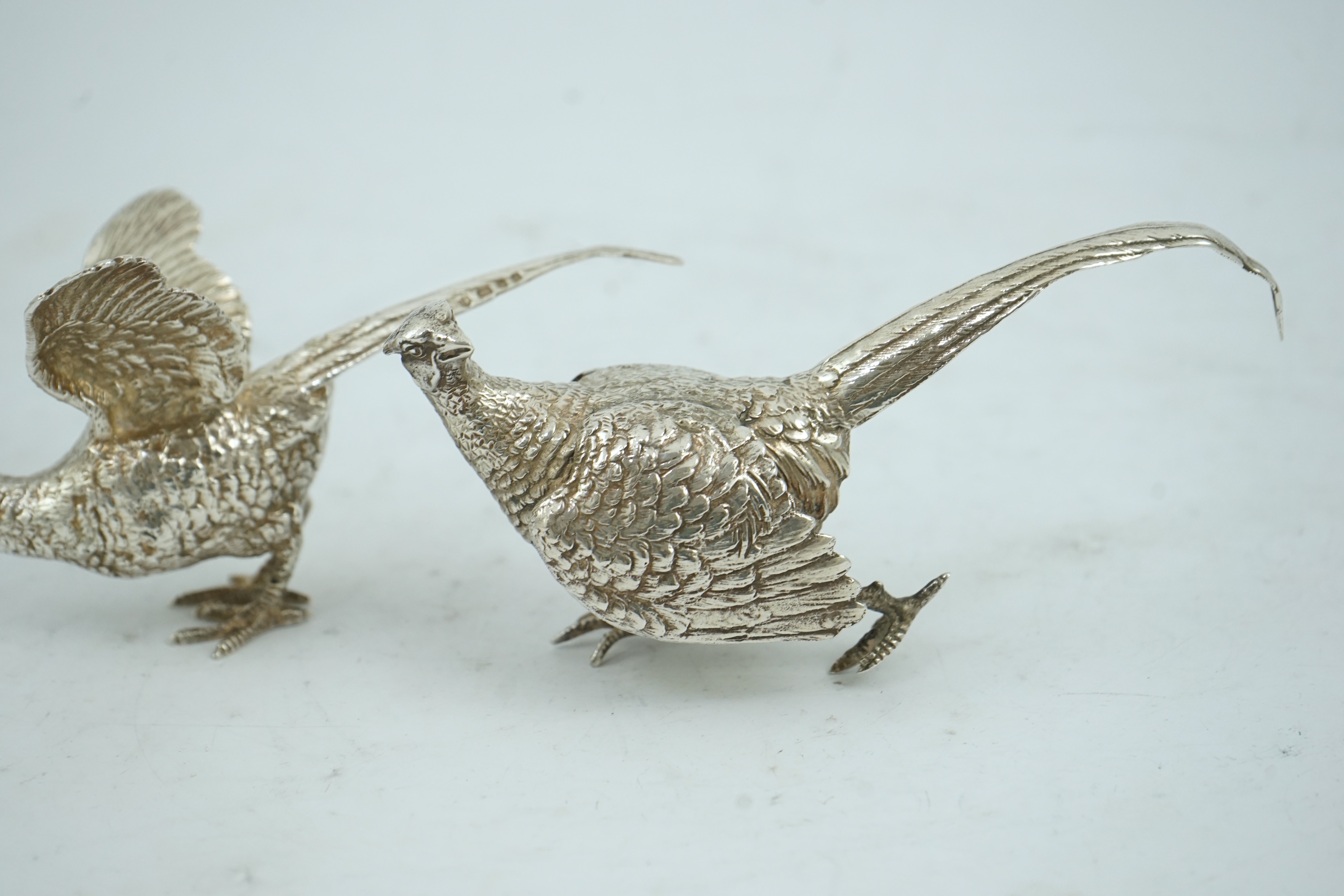 A pair of Elizabeth II silver free-standing model pheasants, by Edward Barnard & Sons Ltd